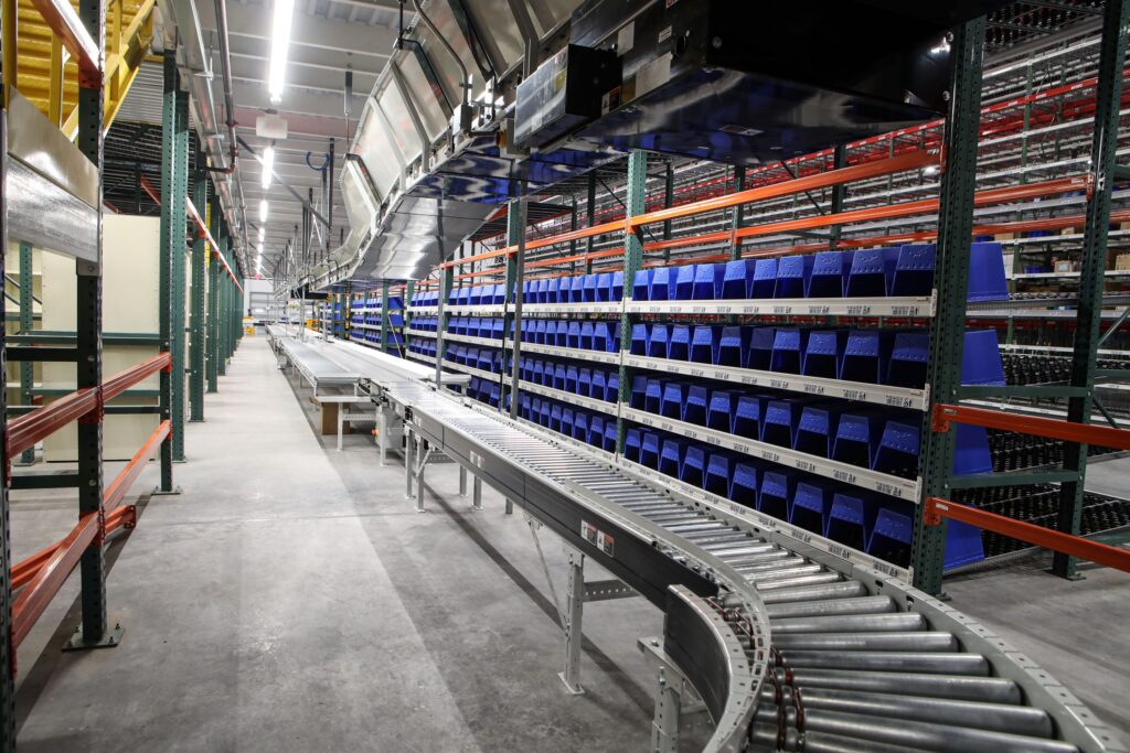Pick Module - Picking from Totes on Carton Flow (right) and Shelving (left)
